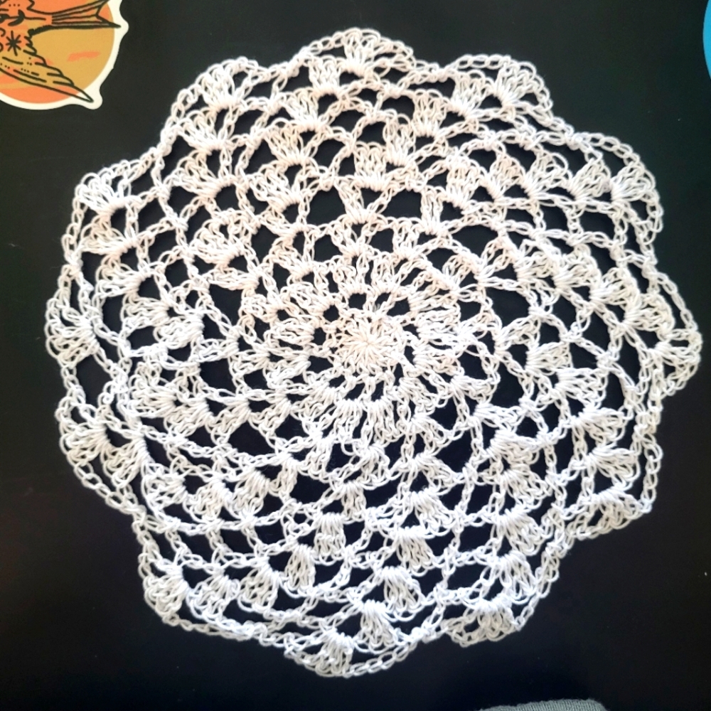 Handmade white crocheted spiral doilie.